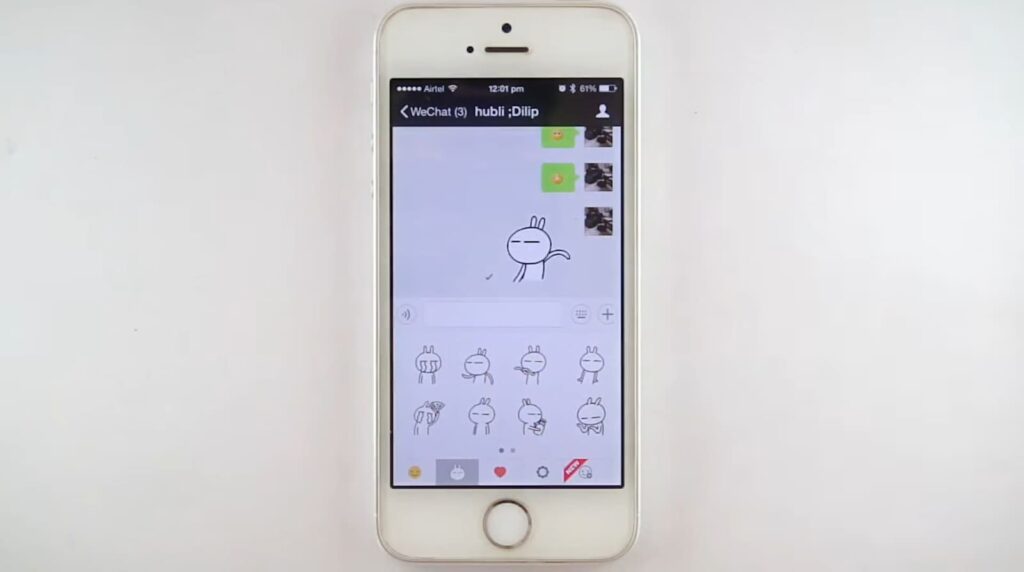 A smartphone displaying a chat interface with stickers and emojis